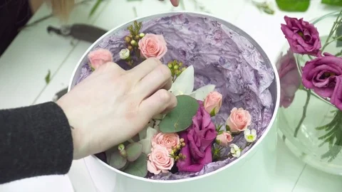 Florist adding a rose to the bouquet in the box Stock Footage 73939005