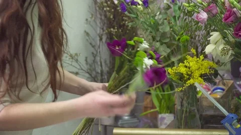 Florist adding some flowers to the bouquet Stock Footage 73947269