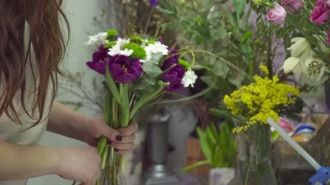 Florist adding some flowers to the bouquet closeup Video stock 73947386