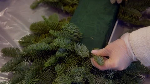 The florist assembles a bouquet of nobilis branches. Close up. Stock Footage 316069679