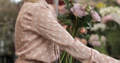 Florist Choosing, Composing, Adjusting Flowers To Make A Bouquet Stock Footage 124578027