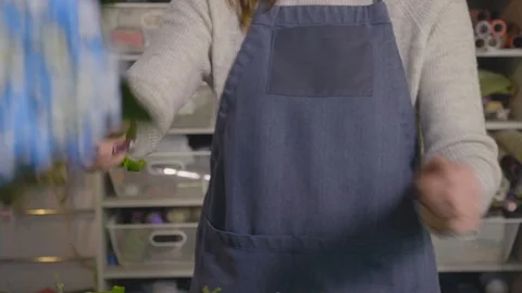 Florist collects a bouquet of hydrangea and roses Stock Footage 125479341