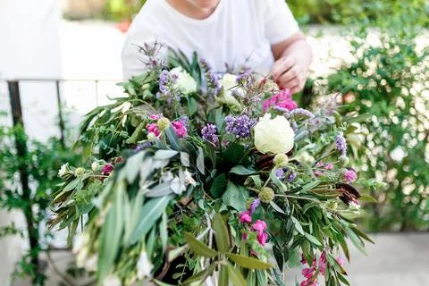 The florist collects eucalyptus branches in the composition Stock Photos