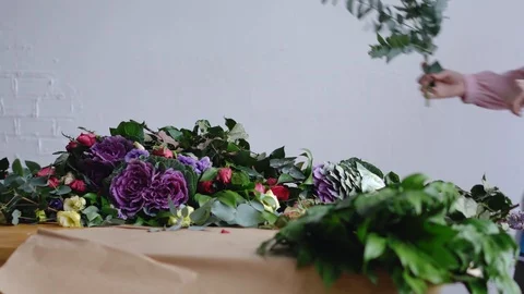 A florist composes a large eucalyptus branch for a bouquet Stock Footage 86745795