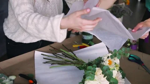 Florist concept. Close up florist makes bouquet on craft table. Work in progress Stock Footage 83345237