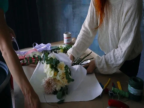 Florist concept. Close up of Young two women red hair florist makes bouquet Vídeo Stock 83345677