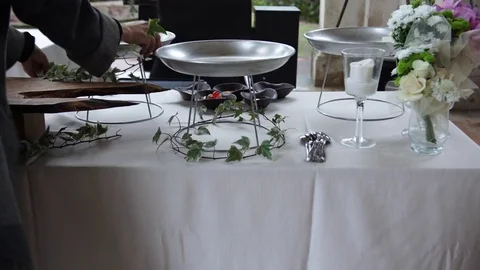 A florist decorating wedding catering table with leaves, 4K Stock-Footage 72442167