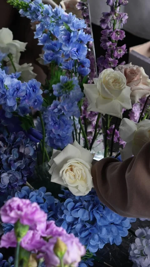 Florist decorator creates romantic wedding flower arrangement near the mirror. P Stock Footage 319045673