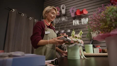 Florist Holding Terminal Accepting Payment of Client at Checkout Counter Stock Footage 321329004