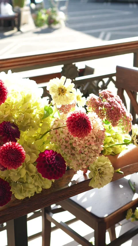 Florist inserts a flower into a wedding flower arrangement in an ekibana for the Stock-Footage 318922166