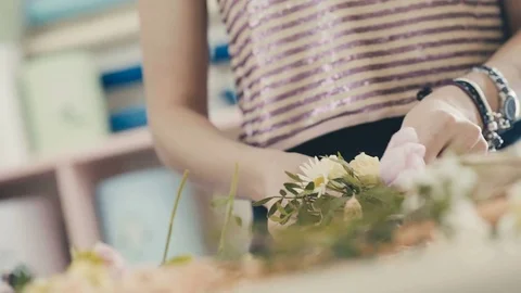 Florist making bouquet. Close up hands of florist with bracelets Stock Footage 73488043