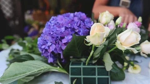 Florist Making Flower Decoration on Table Stock Footage 70986434