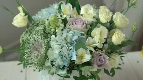 Florist for making a hat box with flowers in a flower shop close-up 4k. Stock Footage 80358833