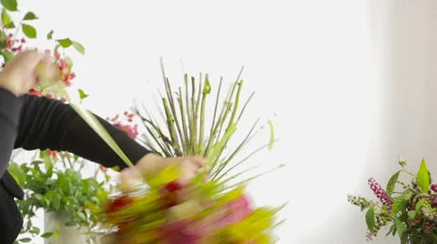 Florist prepares a bouquet of flowers for sale to customers Stock Footage