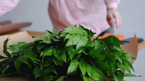 Florist prepares tools to create a beautiful bouquet. Аgainst the background of Stock Footage 85966052