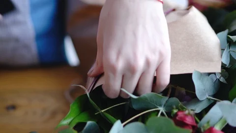 Florist using stapler to attach a craft paper. Close up view of arranging Stock Footage 86801108