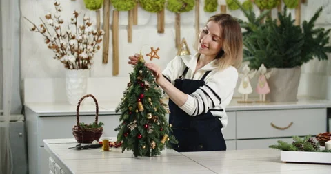 Florist at work: How to make beautiful Christmas decoration in fir shape using Stock Footage 166723235