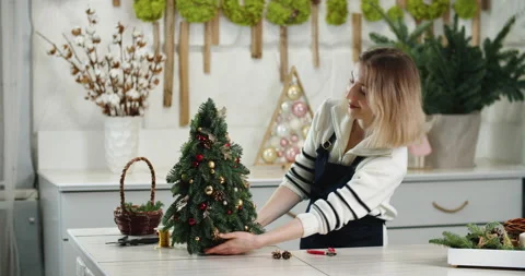 Florist at work: How to make beautiful Christmas decoration in fir shape using Stock Footage 166723332