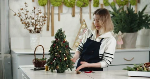 Florist at work: How to make beautiful Christmas decoration in fir shape using Stock Footage 166804952