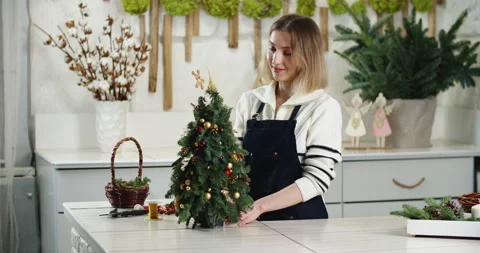Florist at work: How to make beautiful Christmas decoration in fir shape using Stock Footage 166839833