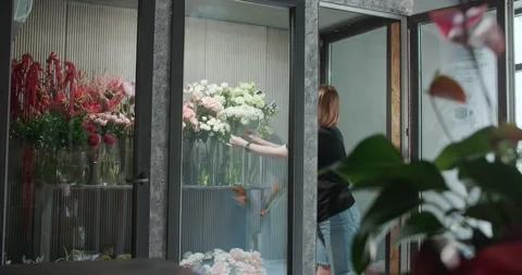 Florist works in flower store Stock Footage 262571899