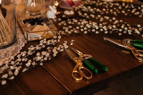 Florist workspace with tools and dried flowers on a wooden table, capturing the Stock Photos