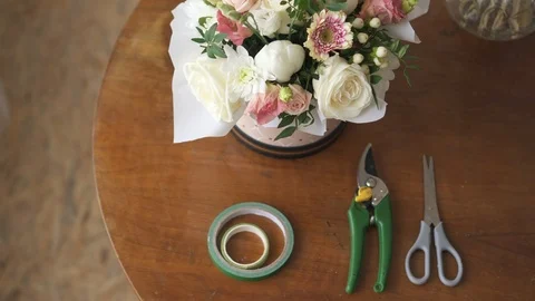 Florist's work desk with tools and bouquets, top view Stock Footage 104355490