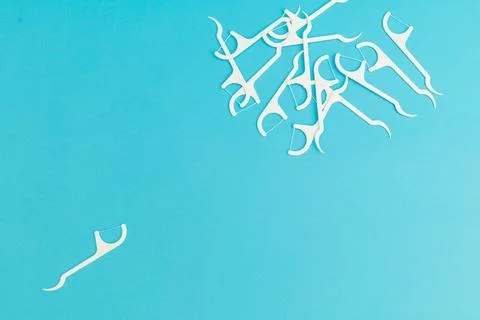 Floss with plastic handle on blue background Stock Photos