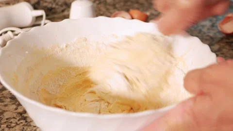 Flour and eggs being mixed on a bowl Stock Footage 152577949