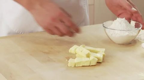 Flour and sugar being added to chopped butter Stock Footage 24641414