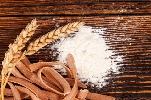 Flour and wheat with spaghetti pasta. Stock Photos