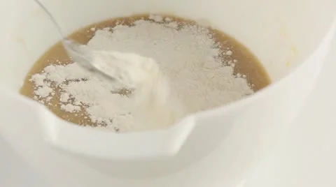 Flour being added to banana bread dough Stock Footage 24672411