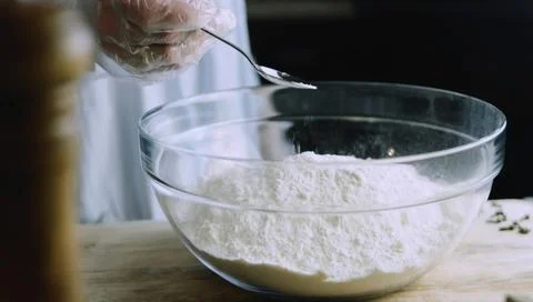 Flour Being Added Gradually to Wet Cookie Batter Stock Photos
