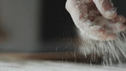 Flour Being Sprinkled by a Chef Onto a Kitchen Work Surface for Burger Prep Vidéo 331100857