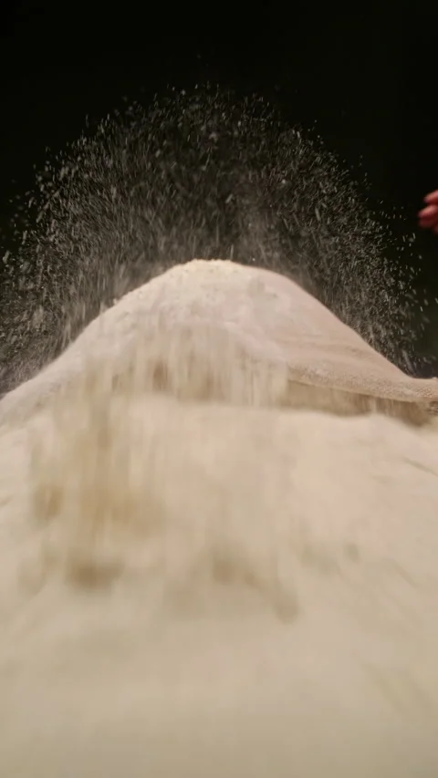 Flour bursts from a sack in slow motion, scattering dust into the air. Stock Footage 320835288