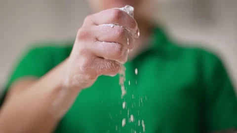 Flour Close-up falling from hand Chef in slow motion. Stock Footage 166594028