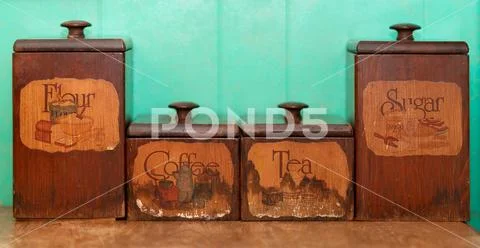 Flour, Coffee, Tea and Sugar wooden storage box on blue wall Stock Photos