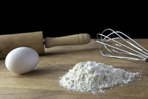 Flour, egg, and utensils. Stock Photos
