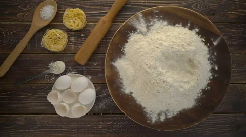 Flour with egg on a dark wooden background Stock Footage 62397444