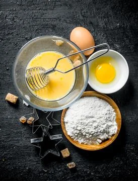 Flour with eggs and forms for the preparation of cookies. Stock Photos