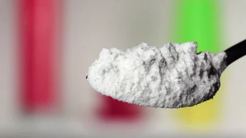 Flour extra class falling from the iron spoon. Blurred background. Slow motion Stock Footage 75522544