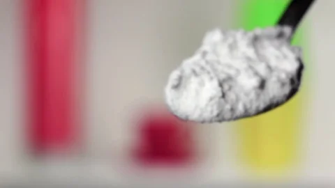 Flour extra class falling from the iron spoon. Blurred background. Slow motion Stock Footage 75522699