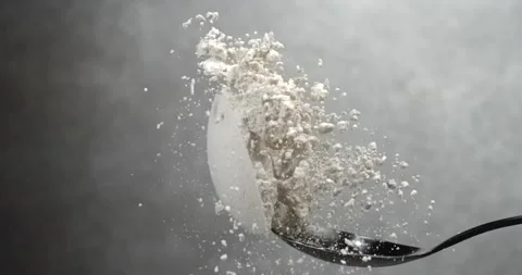 Flour falling from black spoon in super slow motion Stock Footage 344848812