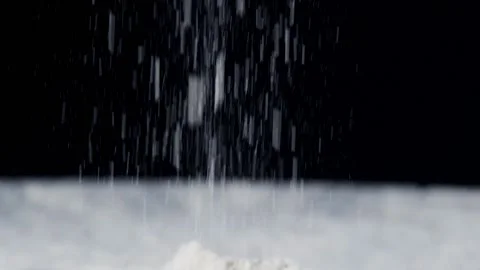 Flour is falling on the black table. Stock Footage 140182427