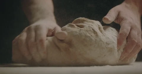 Flour falling on dough and man kneading on counter Stock Footage 254907372