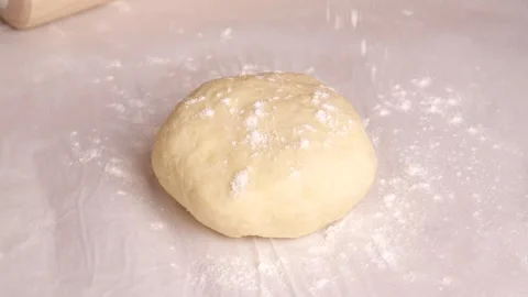Flour falling on dough ball in slow motion Stock Footage 305878261