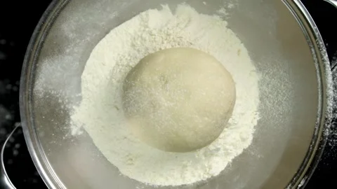 Flour Falling on Dough in Slow Motion Stock Footage 314894163