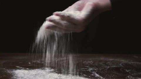 Flour falling from hand. Close-up of making and prepares flour for homemade Stock Footage 131237202