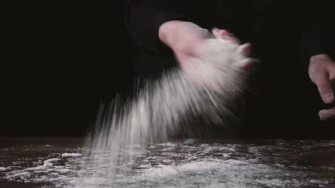 Flour falling from hand. Close-up of making and prepares flour for homemade Stock-Footage 131237311