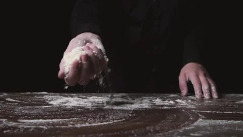 Flour falling from hand. Close-up of making and prepares flour for homemade Stock-Footage 131237448